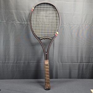 Rossignol Black and Brown Tennis Racket with Red and Yellow Accents